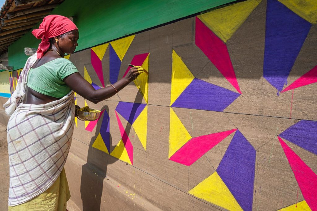 A woman painting a traditional wall design in Saraikela, Jharkhand