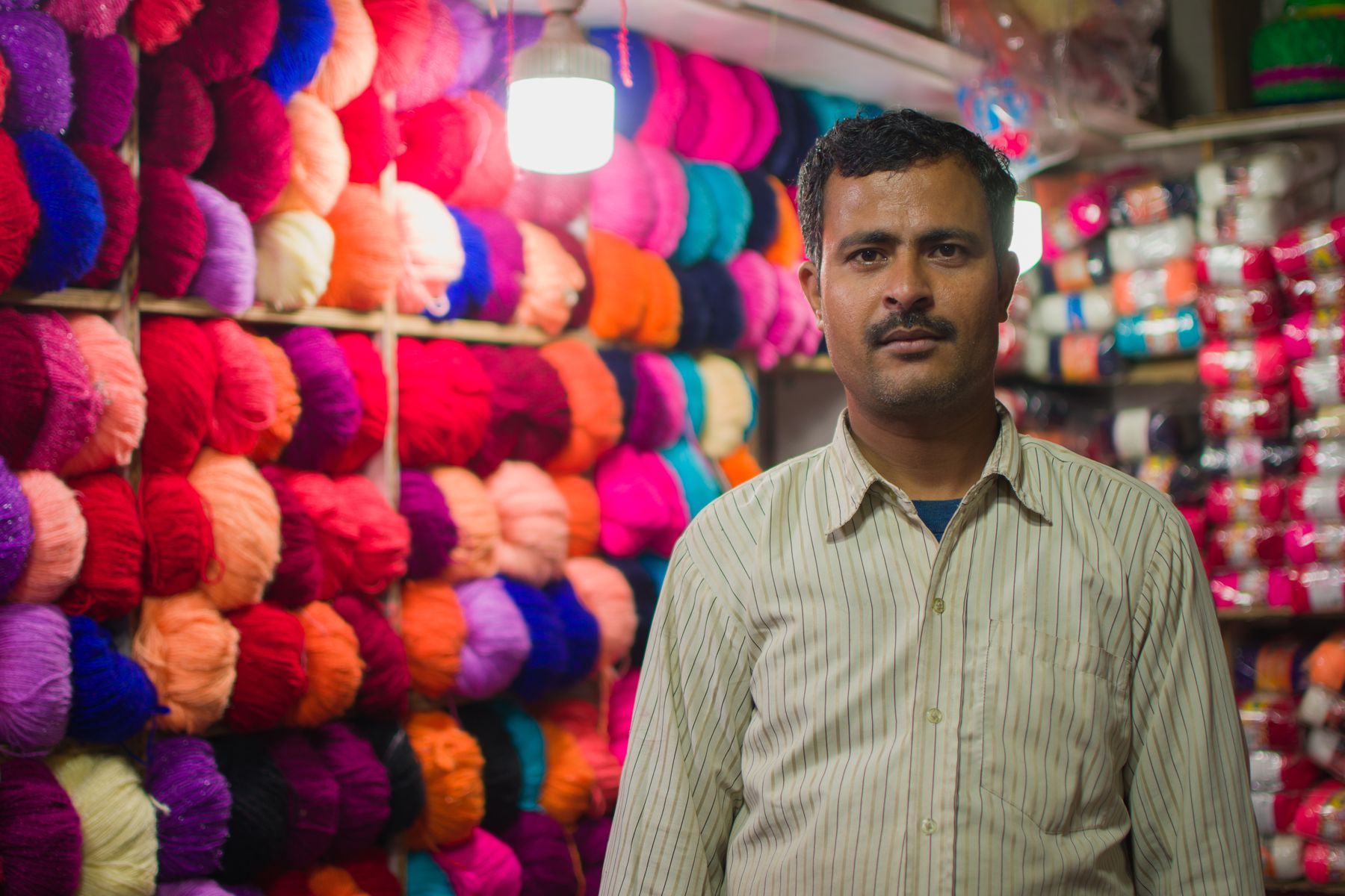A shopkeeper in a yarn shop in Madhubani, India