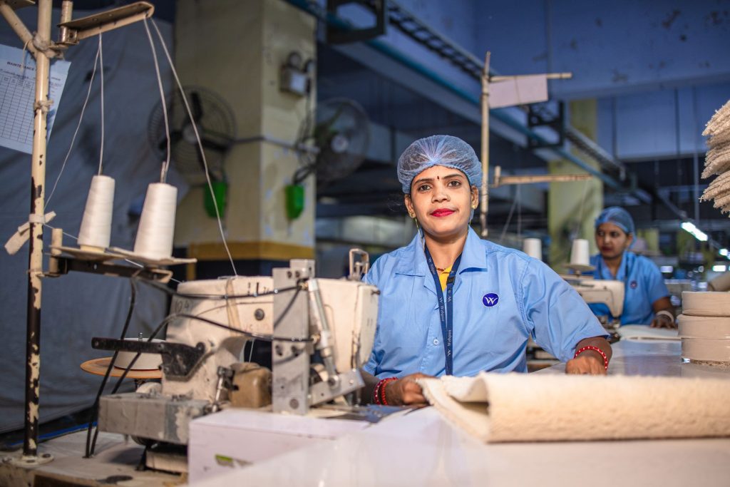 Women working at sewing machines in a garment unit in India