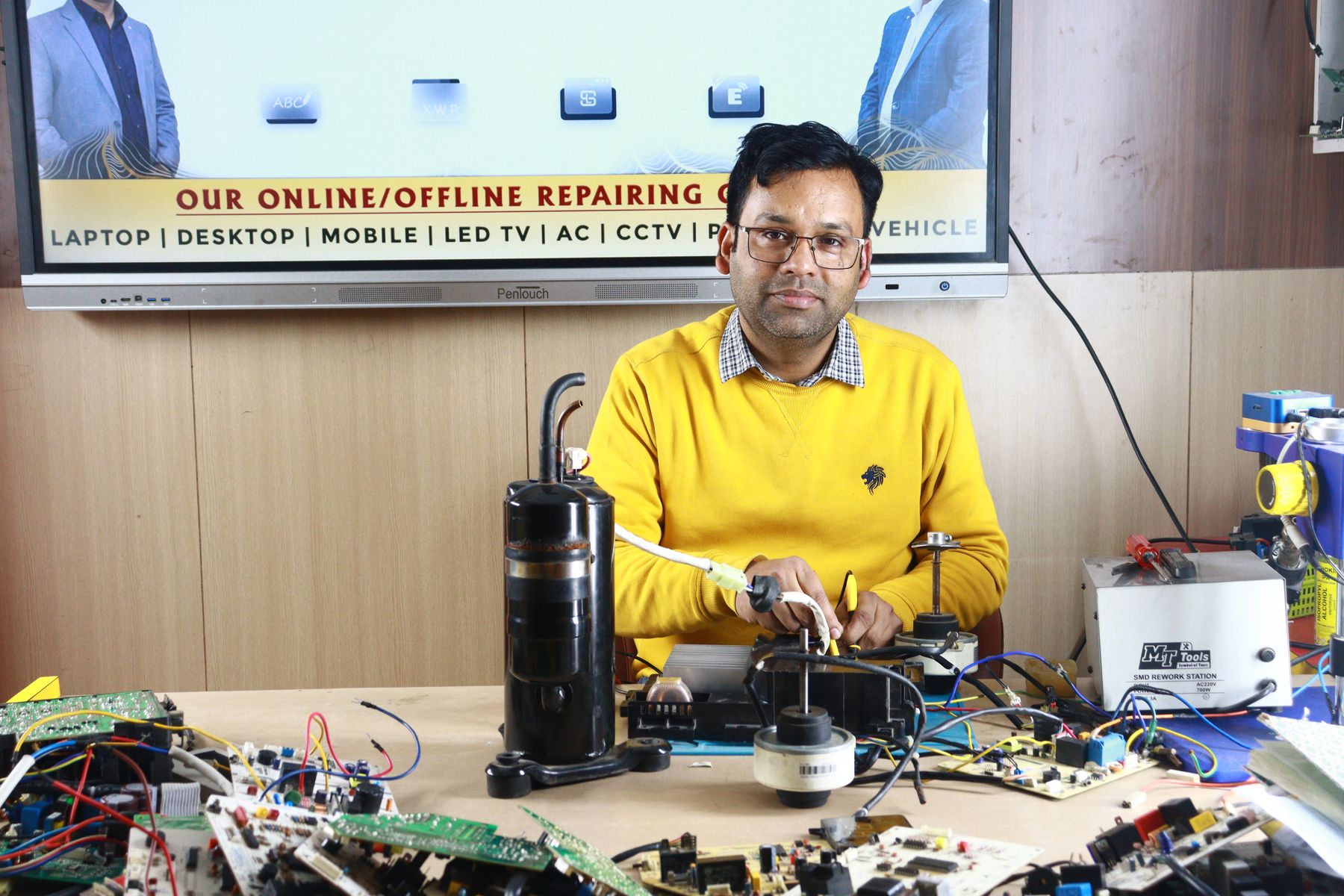 A trainee practising air-conditioner repair at a training centre in New Delhi