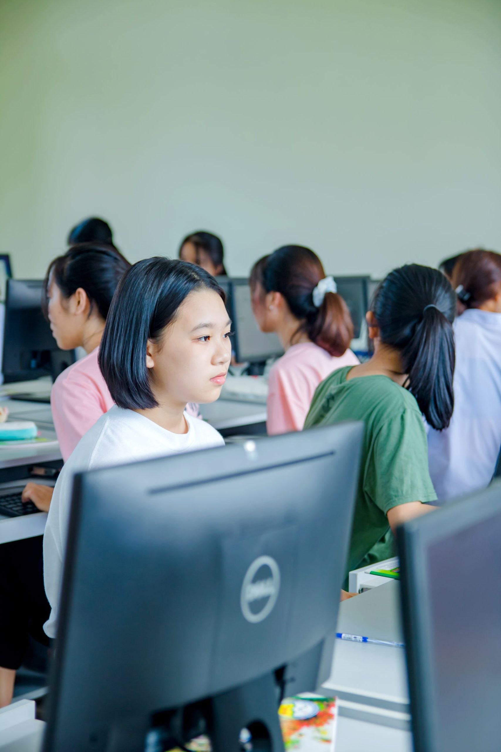 Students studying at workstations in a modern computer lab