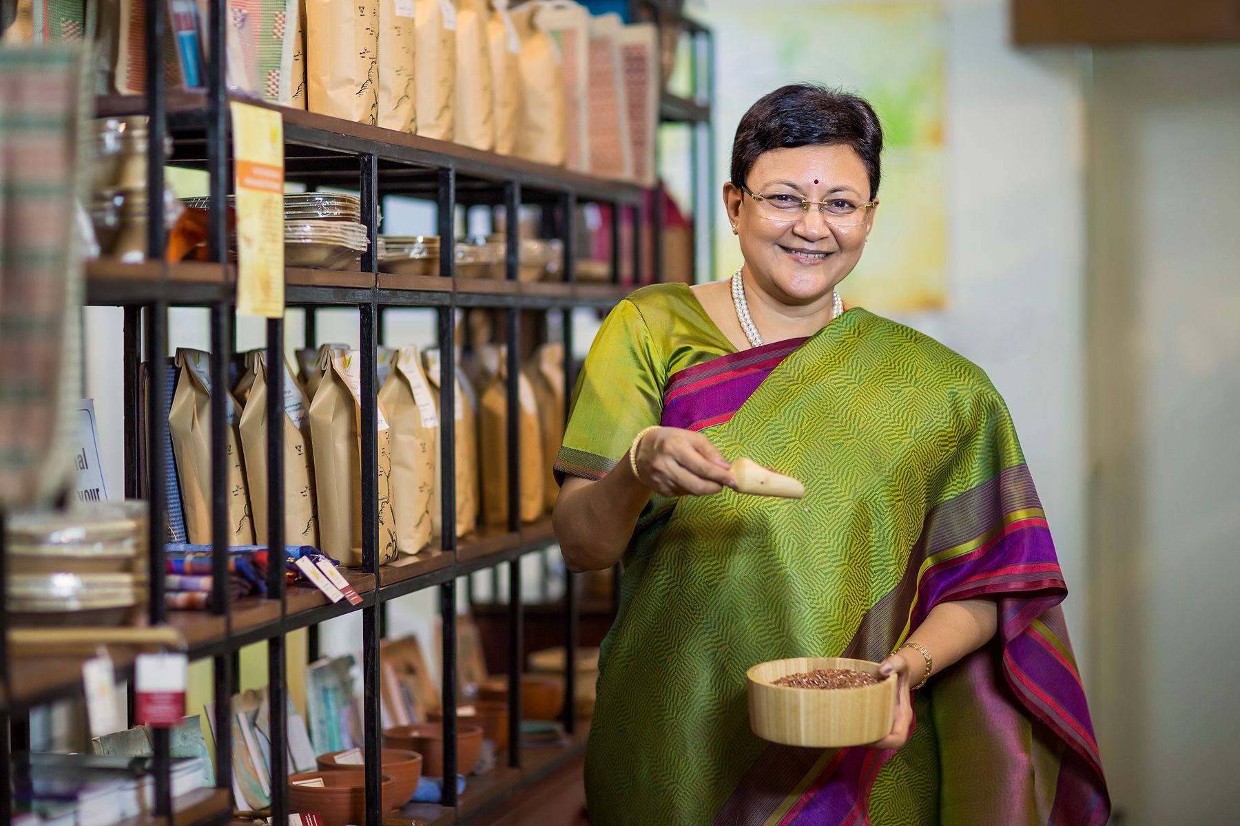 A woman in a sari at work in her shop