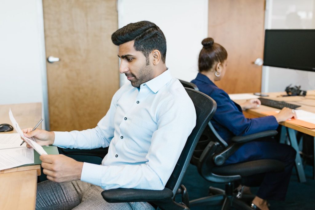Two South Asian professionals working together in an office